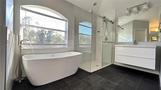 bathroom with tile patterned flooring, vanity, separate shower and tub, and lofted ceiling