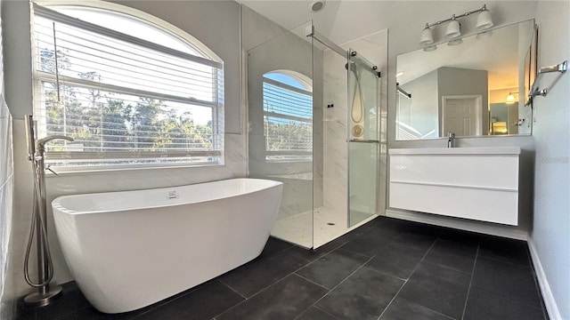 bathroom featuring tile patterned floors, vanity, and independent shower and bath