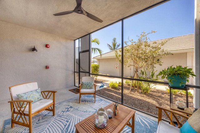 sunroom featuring ceiling fan