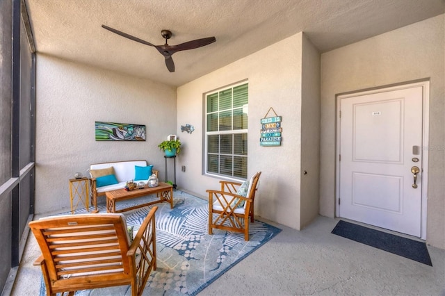 view of exterior entry with ceiling fan