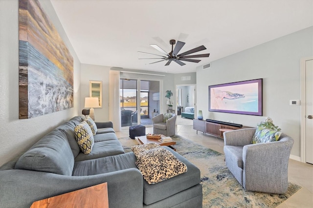 tiled living room with ceiling fan and radiator heating unit