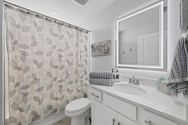 full bathroom featuring vanity, shower / bath combination with curtain, and toilet