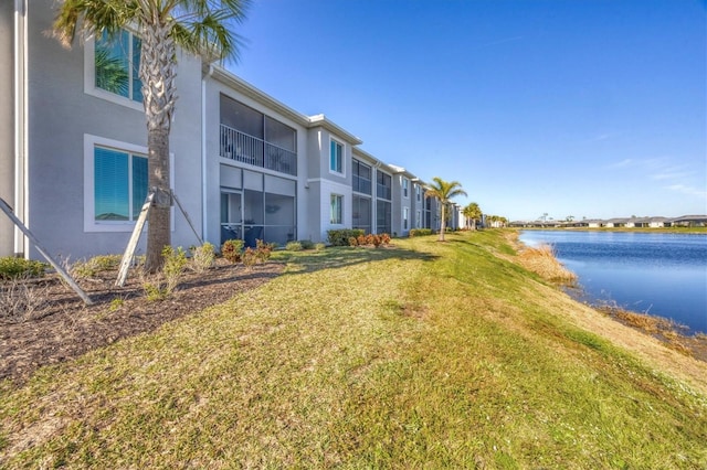 view of community featuring a yard and a water view