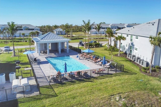 view of pool with a lawn, a patio area, and central air condition unit