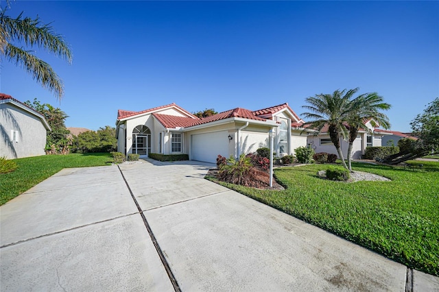 mediterranean / spanish-style home featuring a front yard and a garage