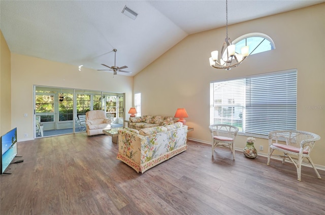 living room with hardwood / wood-style floors, a healthy amount of sunlight, and ceiling fan with notable chandelier