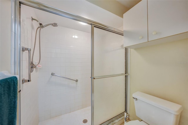 bathroom with walk in shower and toilet