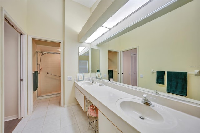 bathroom featuring tile patterned floors, vanity, and a shower with door