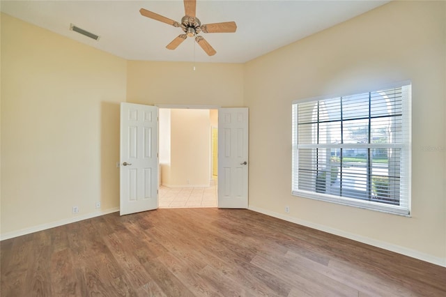 empty room featuring ceiling fan and light hardwood / wood-style floors