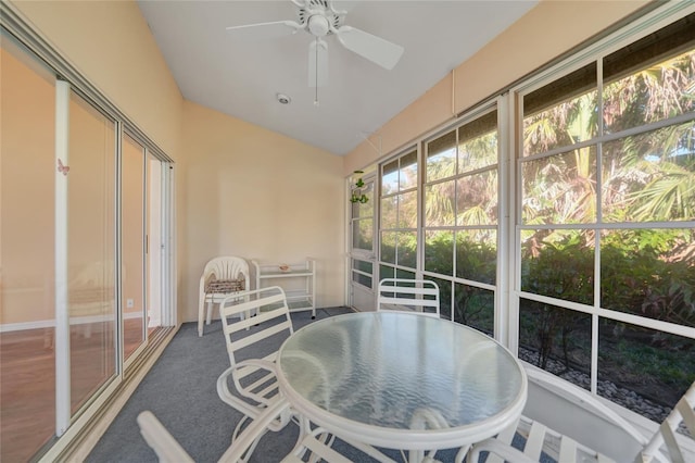 sunroom / solarium with ceiling fan and lofted ceiling