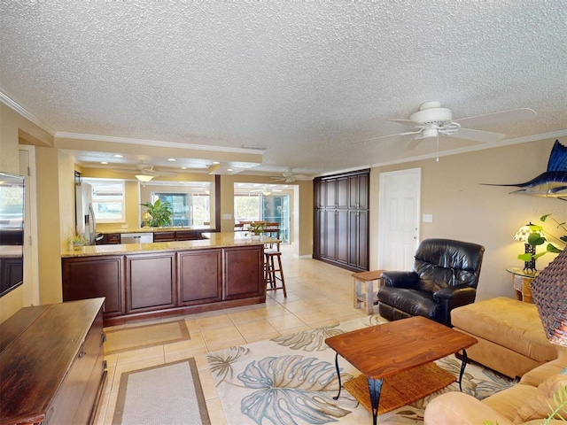 living room with crown molding, light tile patterned floors, and a textured ceiling