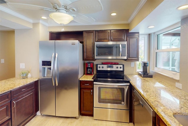 kitchen featuring light stone countertops, ceiling fan, crown molding, and stainless steel appliances