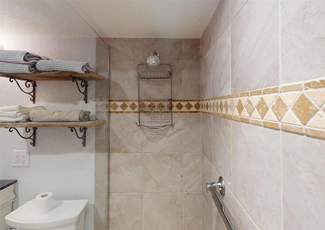 bathroom featuring toilet and tiled shower