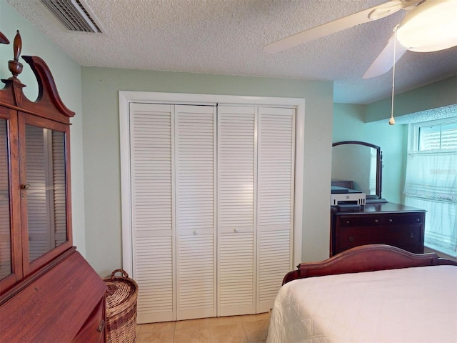 bedroom featuring ceiling fan, a textured ceiling, and a closet