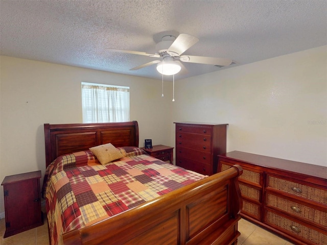 tiled bedroom with a textured ceiling and ceiling fan