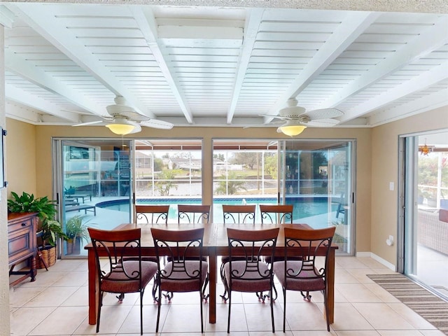 sunroom featuring beamed ceiling, ceiling fan, and a healthy amount of sunlight