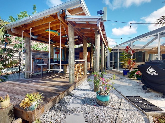 exterior space with a wooden deck and an outdoor bar