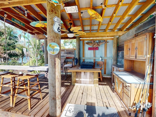 wooden terrace with ceiling fan and an outdoor bar