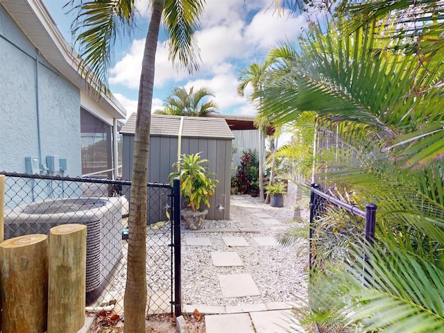 view of patio featuring central air condition unit and a storage unit