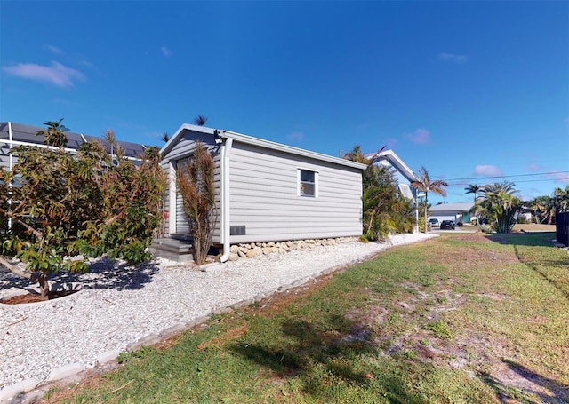 view of property exterior with a lawn