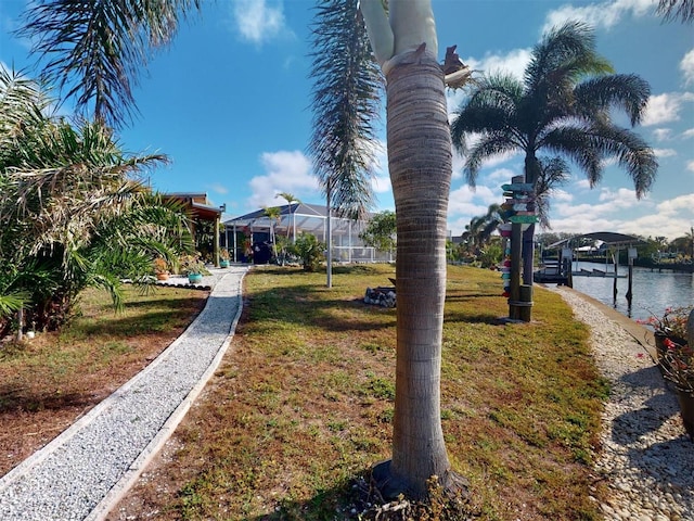 view of yard with a water view and a lanai