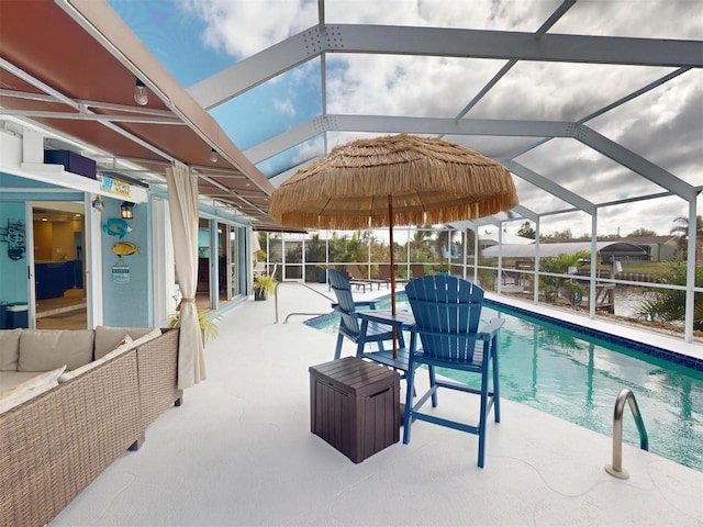 view of pool featuring a lanai, a patio area, and a water view