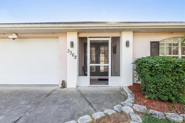 doorway to property with a garage