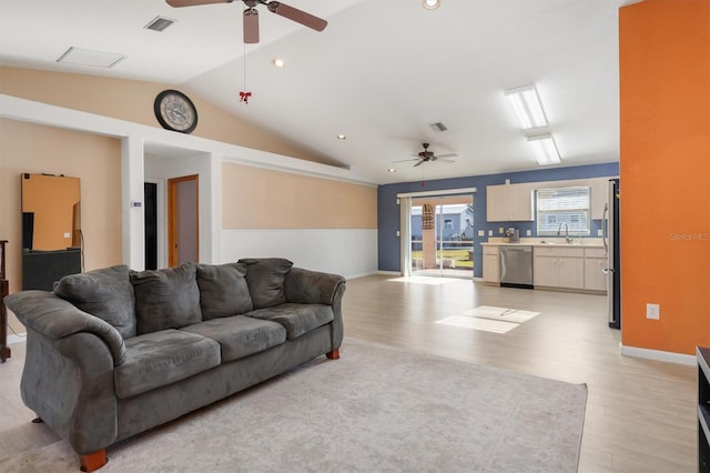 living room featuring light wood-type flooring, ceiling fan, lofted ceiling, and sink