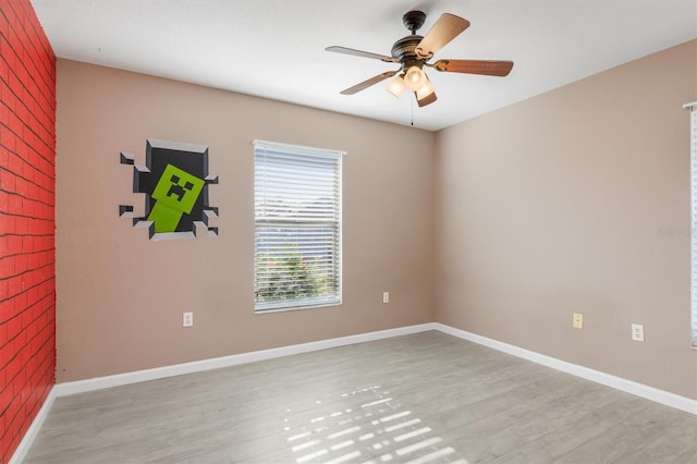 unfurnished room with ceiling fan and light wood-type flooring