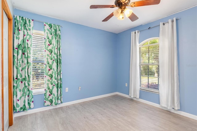 unfurnished room with ceiling fan, plenty of natural light, and light wood-type flooring