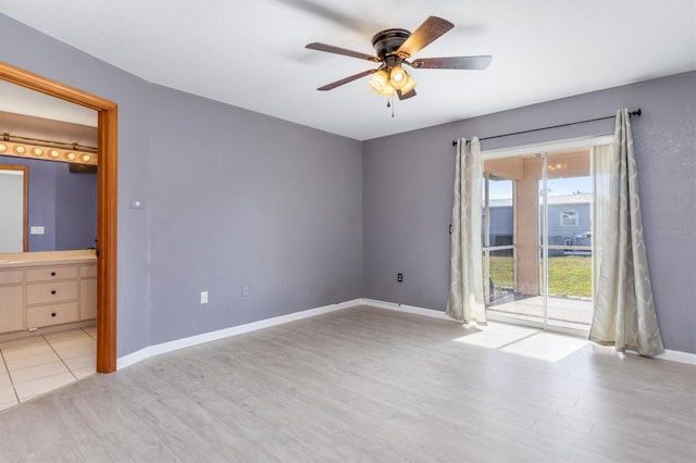 spare room featuring light hardwood / wood-style floors and ceiling fan