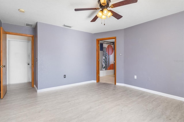 spare room featuring ceiling fan and light hardwood / wood-style floors