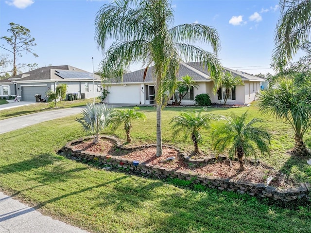 ranch-style house featuring a front yard and a garage