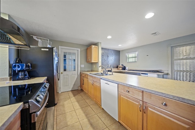 kitchen with range with electric cooktop, dishwasher, light brown cabinets, sink, and wall chimney range hood