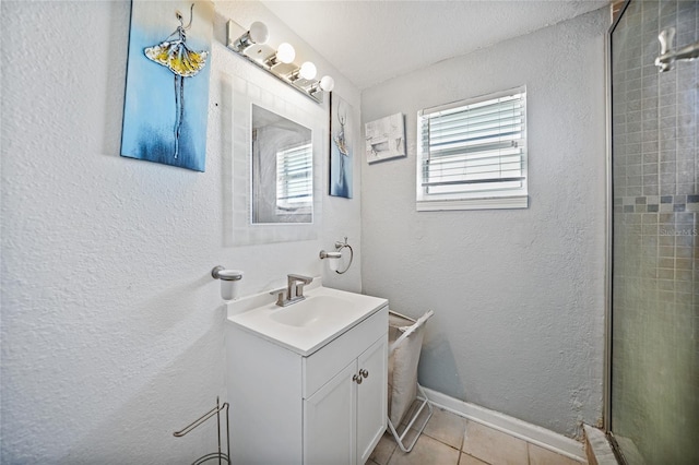 bathroom with tile patterned flooring, vanity, and an enclosed shower