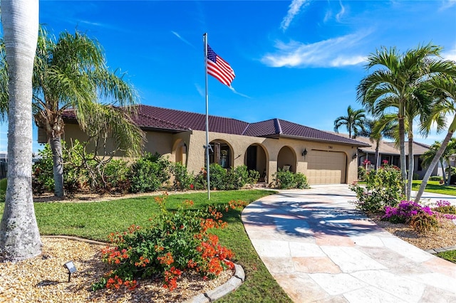 mediterranean / spanish-style home with a garage