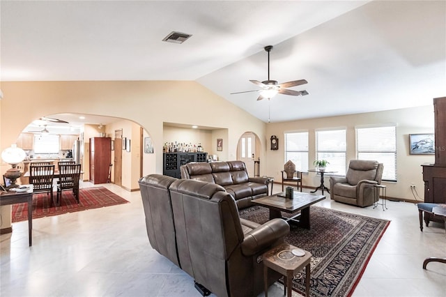 living room with ceiling fan and vaulted ceiling