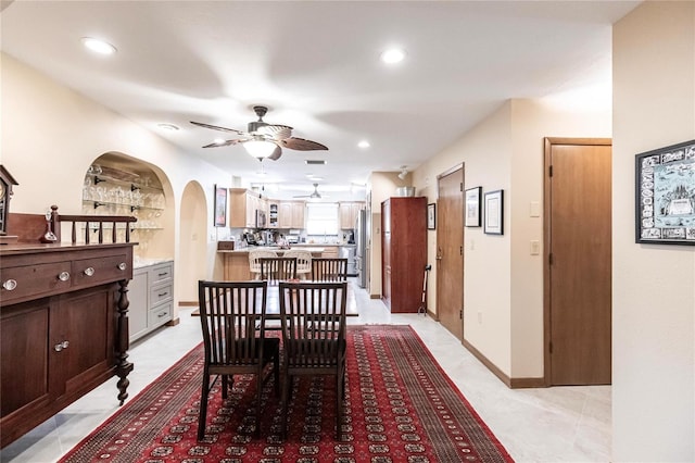 dining area with built in shelves and ceiling fan