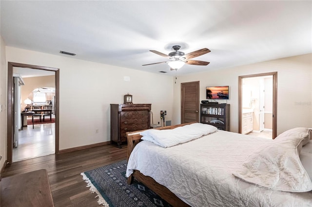 bedroom with ceiling fan, dark hardwood / wood-style flooring, and connected bathroom