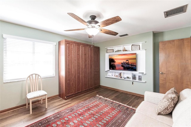 unfurnished living room featuring hardwood / wood-style flooring and ceiling fan