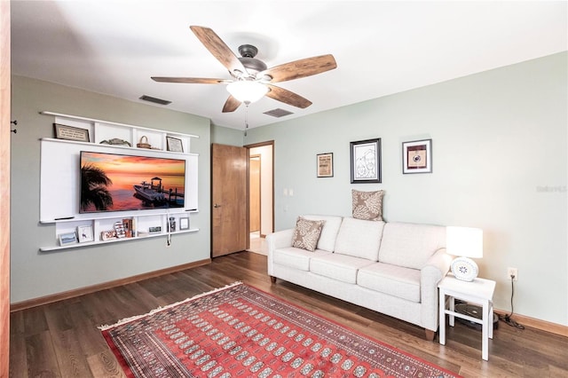 living room featuring dark hardwood / wood-style floors and ceiling fan