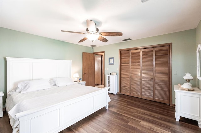 bedroom with ceiling fan, dark hardwood / wood-style flooring, and a closet