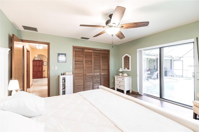 bedroom featuring access to outside, ceiling fan, and a closet