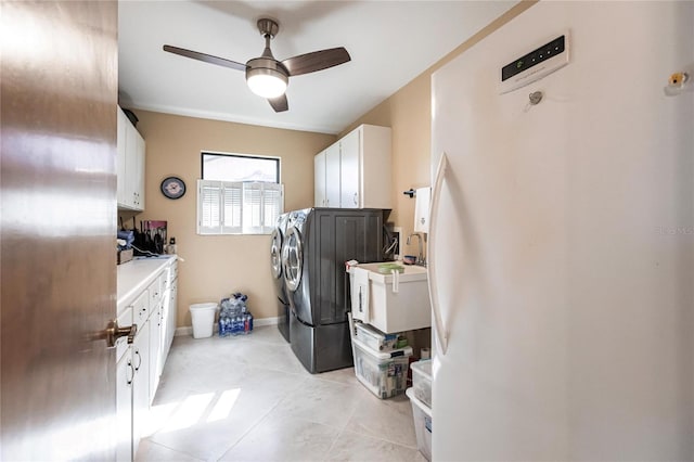 washroom with cabinets, ceiling fan, light tile patterned floors, and washer and dryer