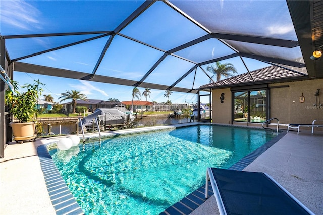 view of pool with a water view, a patio area, and a lanai