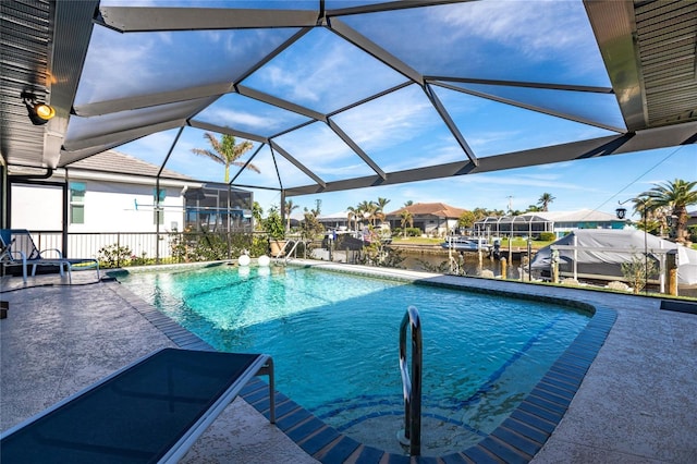 view of swimming pool featuring a patio, a water view, and a lanai