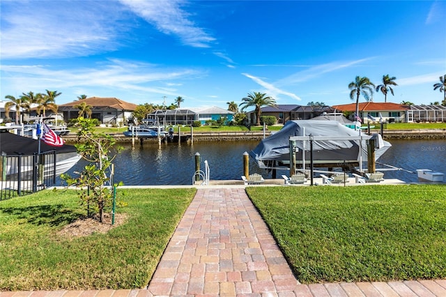 view of dock with a yard and a water view