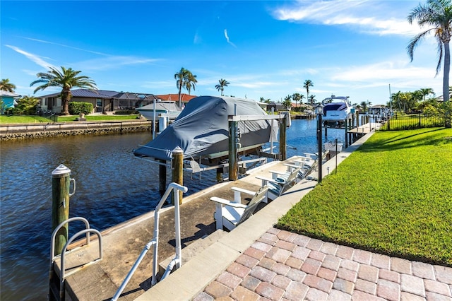 dock area featuring a yard and a water view