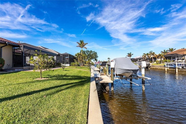 dock area with a yard, a water view, and glass enclosure