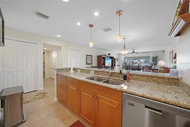 kitchen with ceiling fan, decorative light fixtures, dishwasher, sink, and light stone countertops